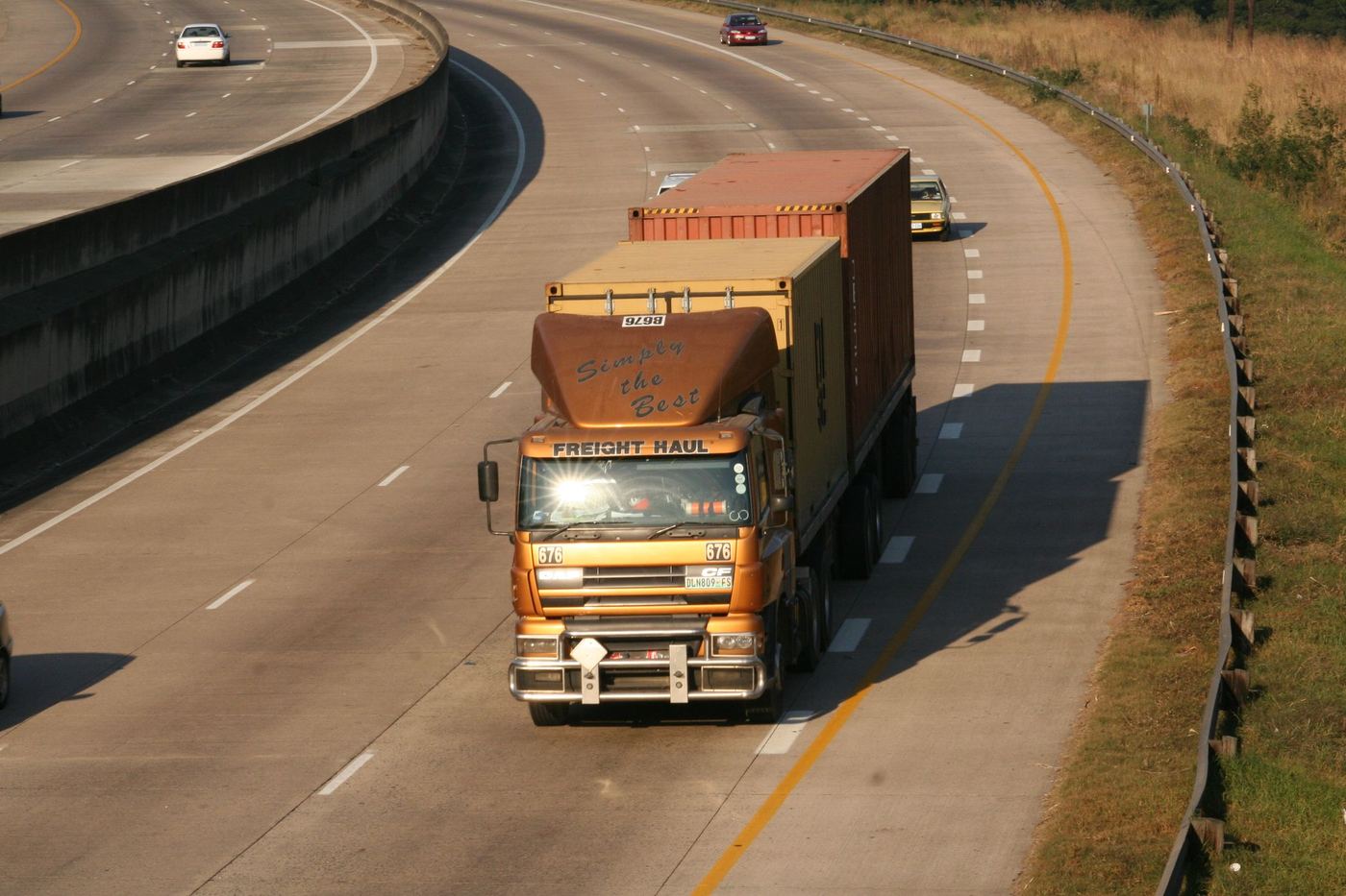 A freight lorry travelling along a curving motorway